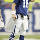 Manning demonstrates the proper form to use while holding the clipboard with one hand and using the headset during third-quarter second-and-long situations.